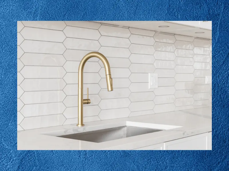 white counter-top with sink and gold faucet